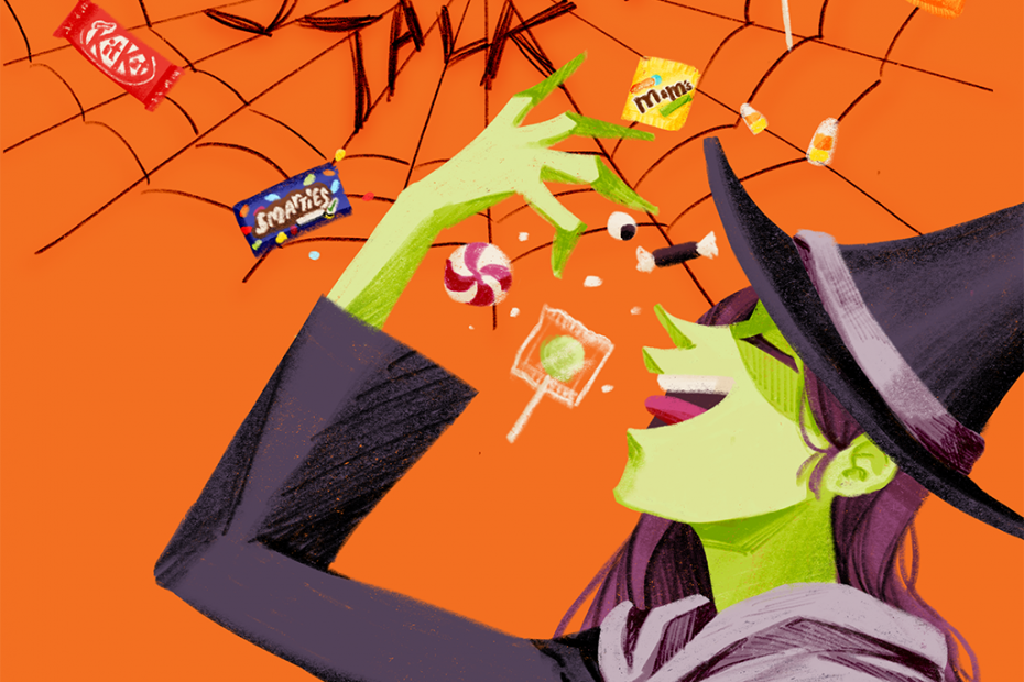 A witch happily devouring assorted Halloween candy.