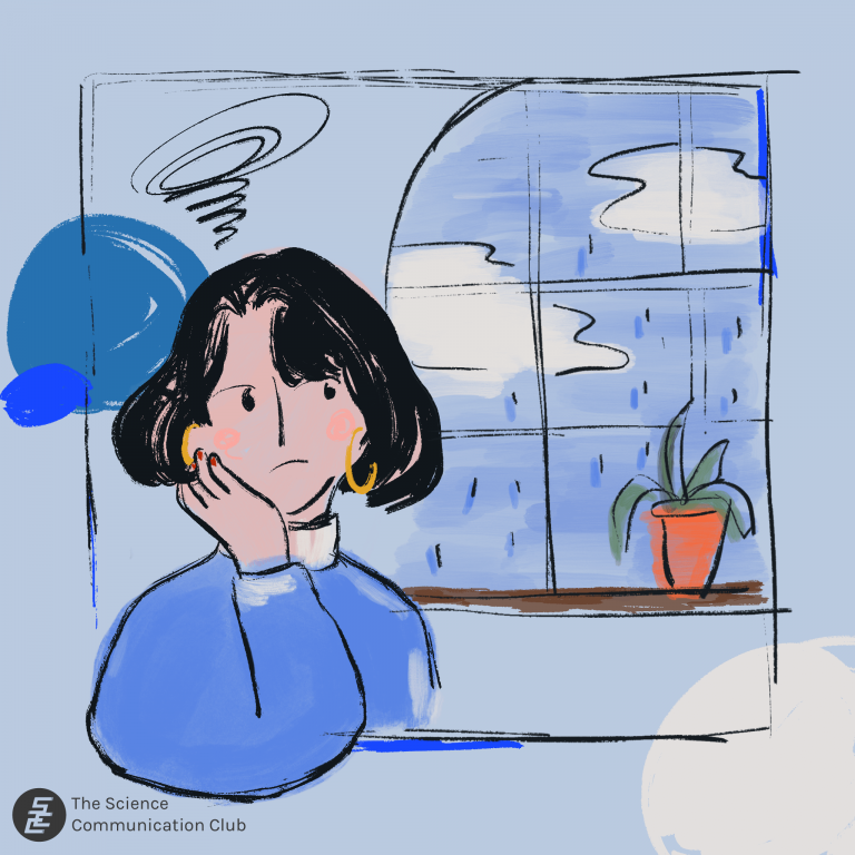 A person sitting next to the window. The weather is gloomy and raining outside the window.