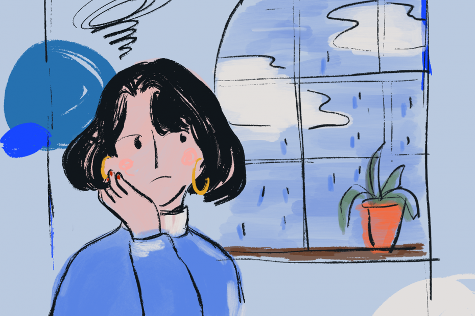 A person sitting next to the window. The weather is gloomy and raining outside the window.